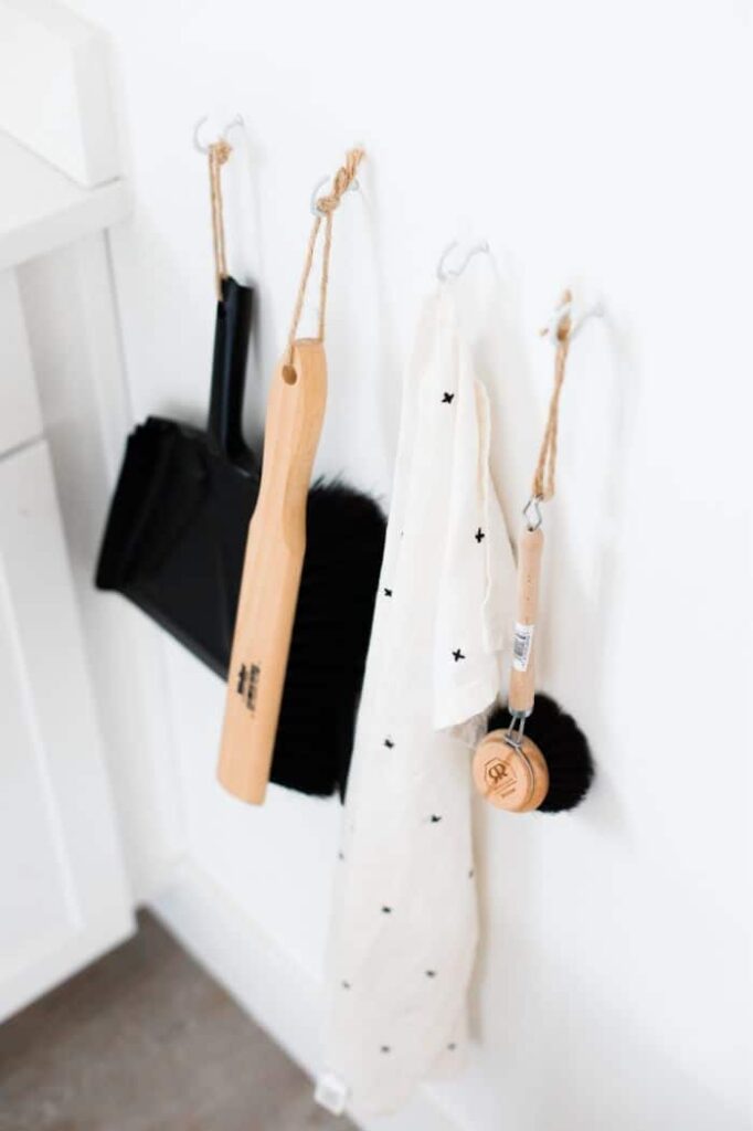 An eco friendly napkin hanging on the wall with various cleaning supplies.